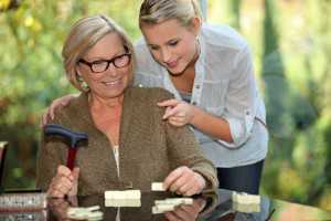 grandmother and granddaughter playing dominoes